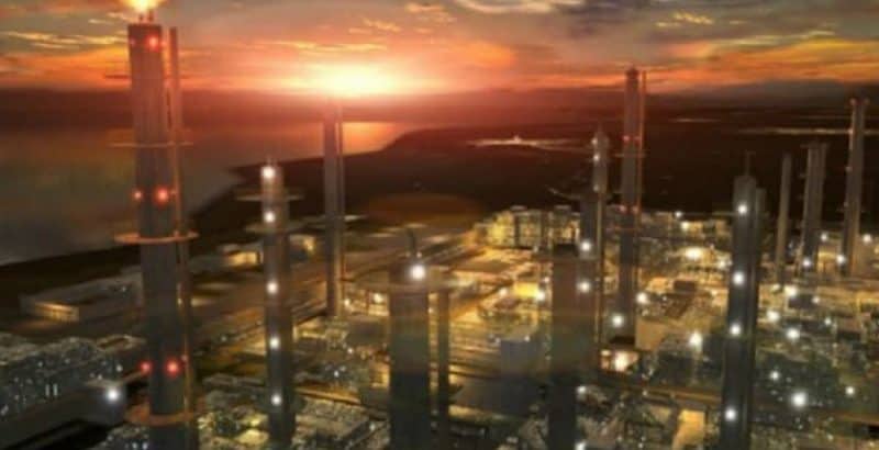 Industrial complex with tall towers and glowing lights at sunset, warm orange and dark tones